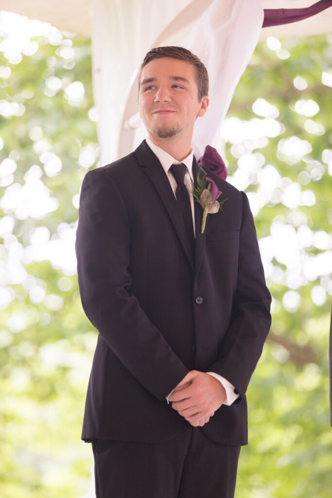 groom with dark boutonniere
